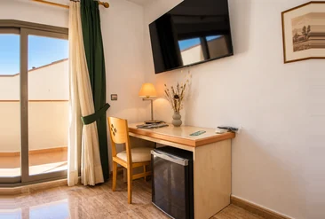 Escritorio y televisión en una habitación de Hotel La Torre